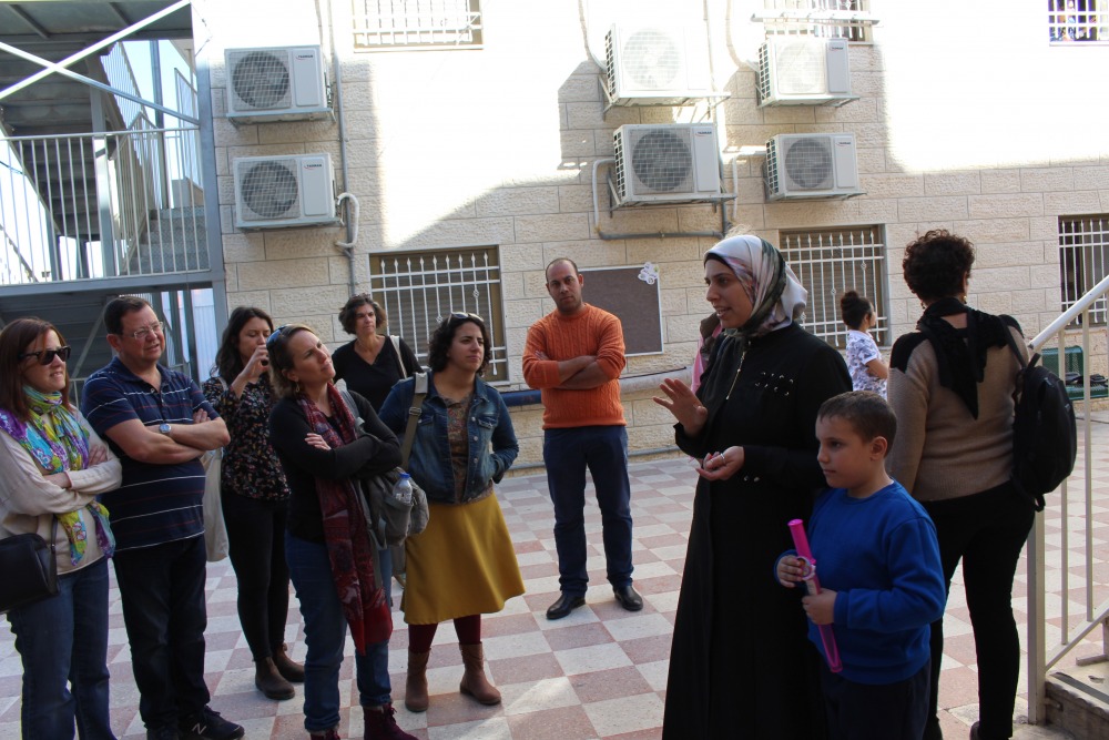 Tour participants toured a girls’ school in Abu Tor with the school’s director. Due to the lack of public space, this school is located in an apartment building rented by the Jerusalem Municipality. Credit: Sheli Zaidman