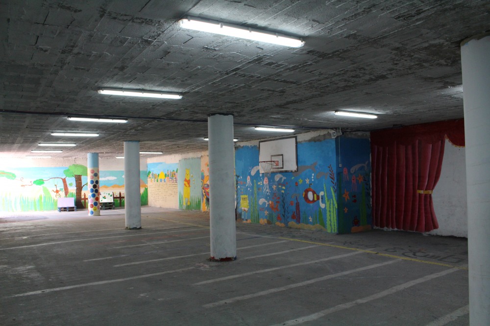 Making due with what little space they have, the girls at this school play in the parking lot underneath one of the buildings. Credit: Sheli Zaidman